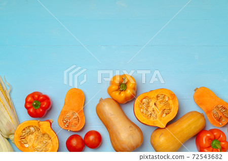 Variety of vegetables including pumpkins on blue pastel background 72543682