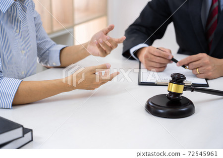 Professional Secretary lawyer working at his office signing contract Consultation of client from trust Law Firm, Attorneys Notary Law and Legal services concept 72545961