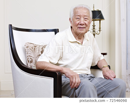 portrait of an asian senior man sitting in an armchair 72546098