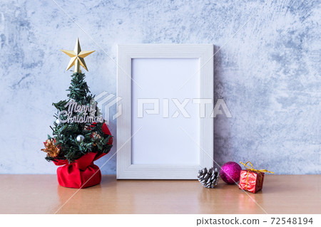 Picture frame and Christmas decoration - Santa Clause and gift on wooden table. Christmas and Happy new year concept Picture frame and Christmas decoration - Santa Clause and gift on wooden table. Christmas and Happy new year concept 72548194