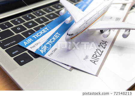 laptop computer and airplane and money on table. Online ticket booking concept laptop computer and airplane and money on table. Online ticket booking concept 72548213