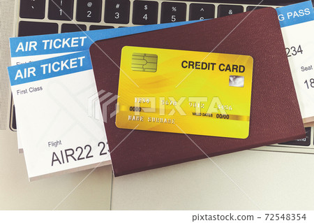 Credit card and passports near laptop computer on table. Online ticket booking concept 72548354