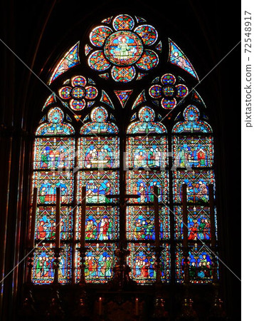 Stained glass of Notre Dame Cathedral where natural light is reflected vividly 72548917