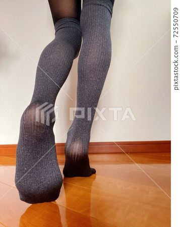 Legs of a woman standing in tights on the floor Legs of a woman standing in tights on the floor 72550709