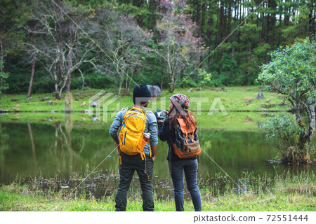 Asian couples, relax on holiday. travel nature taking photographs pink sakura. 72551444