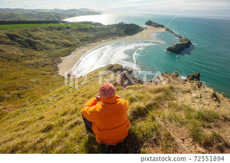 Man on New Zealand coast 72551894