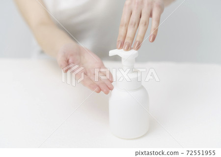Woman foaming from a bottle Woman foaming from a bottle 72551955