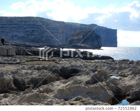 Malta Gozo Rocky coast and huge rocky island Hungas Rock 72552862