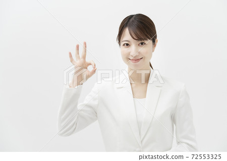 Business woman doing "OK sign" Business woman doing "OK sign" 72553325
