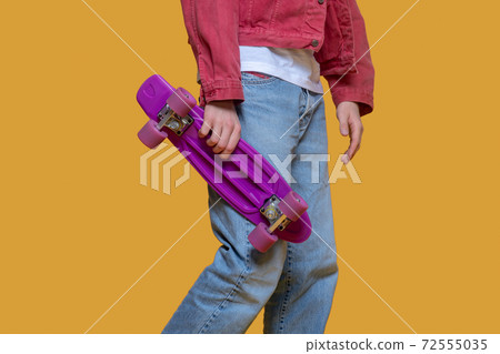 Man in red jacket holding a skateboard 72555035