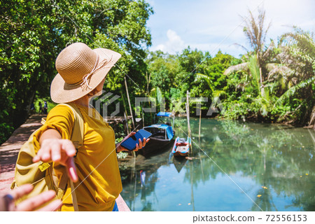Asian couple holding hands, traveling nature. Travel relax. at tha pom-klong-song-nam. Krabi, in Thailand. Travel Thailand. Honeymoon, romantic. Asian couple holding hands, traveling nature. Travel relax. at tha pom-klong-song-nam. Krabi, in Thailand. Travel Thailand. Honeymoon, romantic. 72556153
