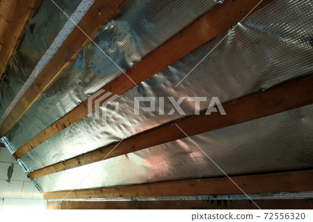Insulation of the roof of the house on the inside with the use of a wrapper film and fixing boards Insulation of the roof of the house on the inside with the use of a wrapper film and fixing boards 72556320