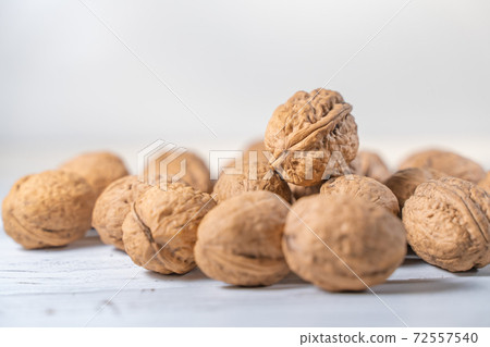 Walnuts kernels on white wooden desk, stock photo Walnuts kernels on white wooden desk, stock photo 72557540