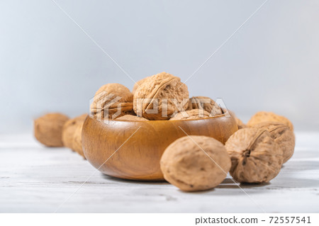 Walnuts kernels on white wooden desk, stock photo Walnuts kernels on white wooden desk, stock photo 72557541
