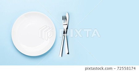 Empty plate, fork and knife Empty plate, fork and knife 72558174