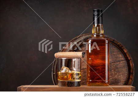 Scotch whiskey bottle, glass, cigar and old barrel 72558227