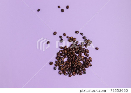 Brown coffee beans heap on purple background with copy space. Horizontal banner Brown coffee beans heap on purple background with copy space. Horizontal banner 72558660