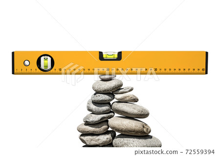 Construction Spirit Level on a Pile of Stones in Balance 72559394