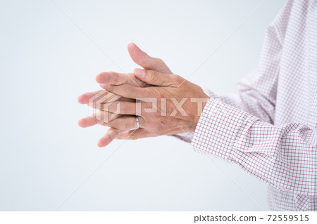 Senior man disinfecting with alcohol spray Senior man disinfecting with alcohol spray 72559515