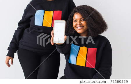 African american woman showing blank phone screen, mockup African american woman showing blank phone screen, mockup 72560329