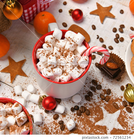 sweet food top view background for merry christmas or new year holiday decoration - chocolate candies, tangerines, cookies, marshmallow and cocoa latte on white wood 72561234