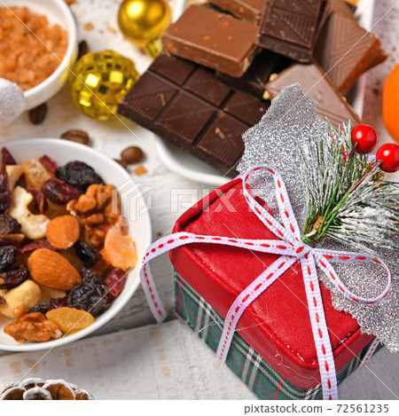 sweet food top view background for merry christmas or new year holiday decoration - chocolate candies, tangerines, cookies on white wood 72561235