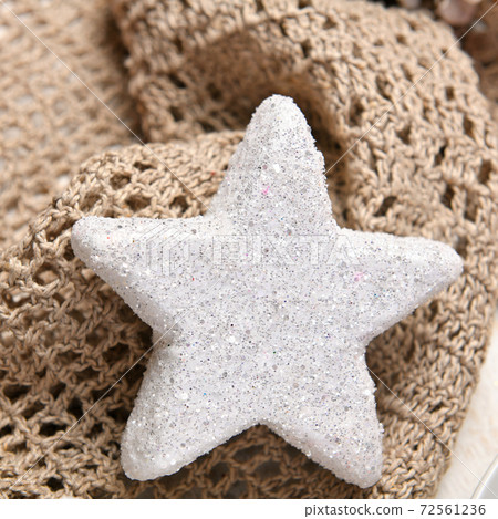 a white star on wool textile, background for christmas or holiday decoration 72561236