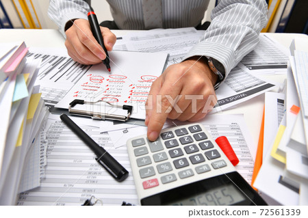 business concept - businessman working with reports in office, table and workspace close view, analyzing financial data, writes and counts 72561339