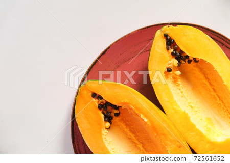 close up of slice of papaya on plate  72561652