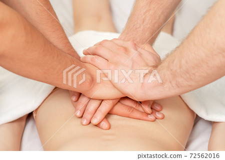 Back massage with four hands. Back massage with four hands. 72562016