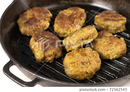 Juicy Homemade meat burger patties cutlet beef, pork, chicken, turkey in black cast iron frying pan 72562543
