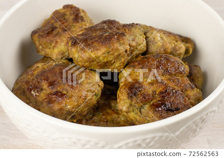 Homemade meat beef burger patties cutlet heap on white plate table background. Ketogenic diet Homemade meat beef burger patties cutlet heap on white plate table background. Ketogenic diet 72562563