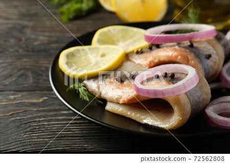 Concept of tasty lunch with herring fish on wooden background Concept of tasty lunch with herring fish on wooden background 72562808