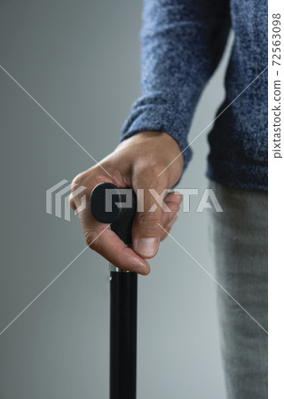 man using a walking stick man using a walking stick 72563098