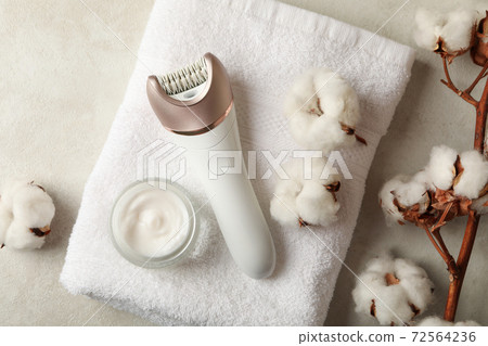 Towel, epilator, cotton and cream on white background Towel, epilator, cotton and cream on white background 72564236