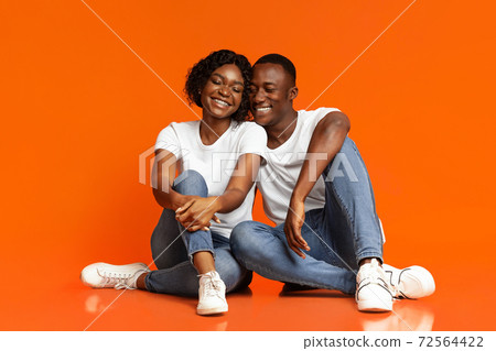 Loving black man and woman having fun, studio shot Loving black man and woman having fun, studio shot 72564422