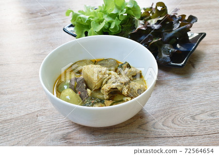 spicy boiled chicken with eggplant in coconut milk green curry soup on bowl 72564654