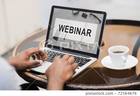 Unrecognizable black man attending webinar while sitting at cafe 72564676