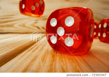 Red dice tossed on wooden background close up Red dice tossed on wooden background close up 72565447