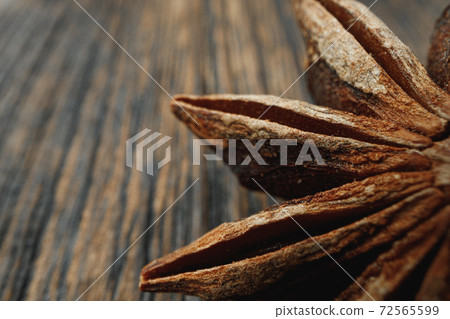 Macro photo of anise stars on wooden background Macro photo of anise stars on wooden background 72565599