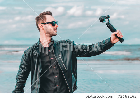 Handsome Guy Making Selfie at the Beach Handsome Guy Making Selfie at the Beach 72568162
