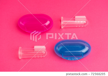 Compact toothbrush fingertip. Travel hygiene close up Compact toothbrush fingertip. Travel hygiene close up 72568205