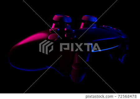 Realistic video game controller in neon lights on black noir background Realistic video game controller in neon lights on black noir background 72568478