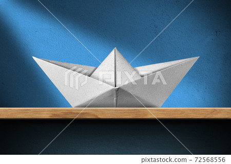 White paper boat on the shelf at home White paper boat on the shelf at home 72568556