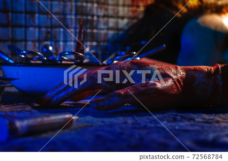 A creepy room with bloodstained walls and medical instruments. A creepy room with bloodstained walls and medical instruments. 72568784