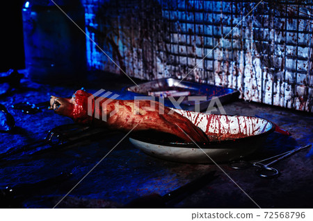 Human limbs and remains are covered in blood. Creepy and gloomy room for medical experiments 72568796