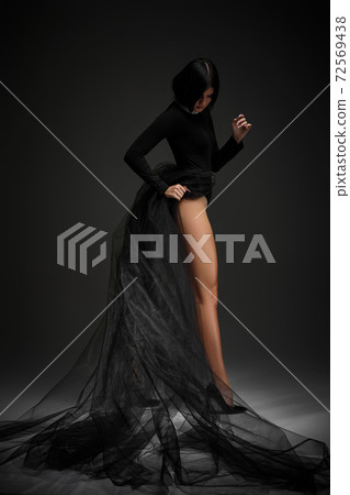 sexy brunette woman in long black dress sexy brunette woman in long black dress 72569438