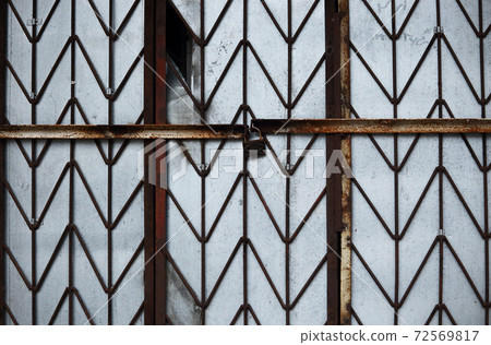 Rusty gilded wall protective lattice with padlock Rusty gilded wall protective lattice with padlock 72569817