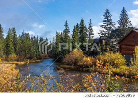 Spring creek and Canmore Opera House in autumn season sunny day morning. Town of Canmore, Alberta, Canada. 72569959