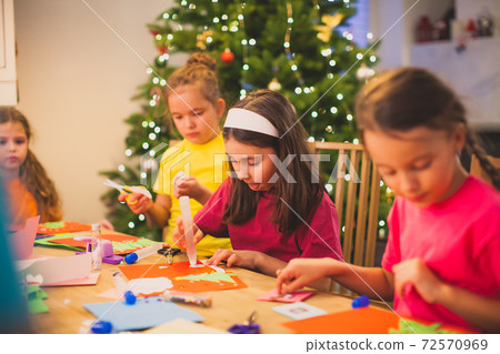 Cooperation and support between kids while Christmas workshop Cooperation and support between kids while Christmas workshop 72570969
